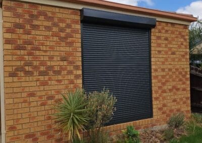 House with orange brick and black shutters