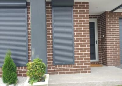 a brick house with a door and a planter