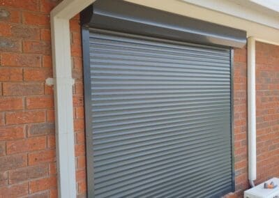 a building with a window and a air conditioner