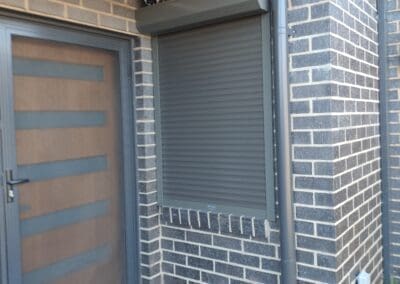a door and window on a brick building