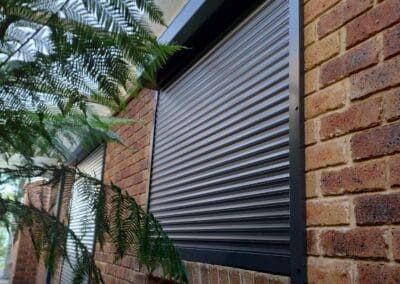 a brick building with a shutter