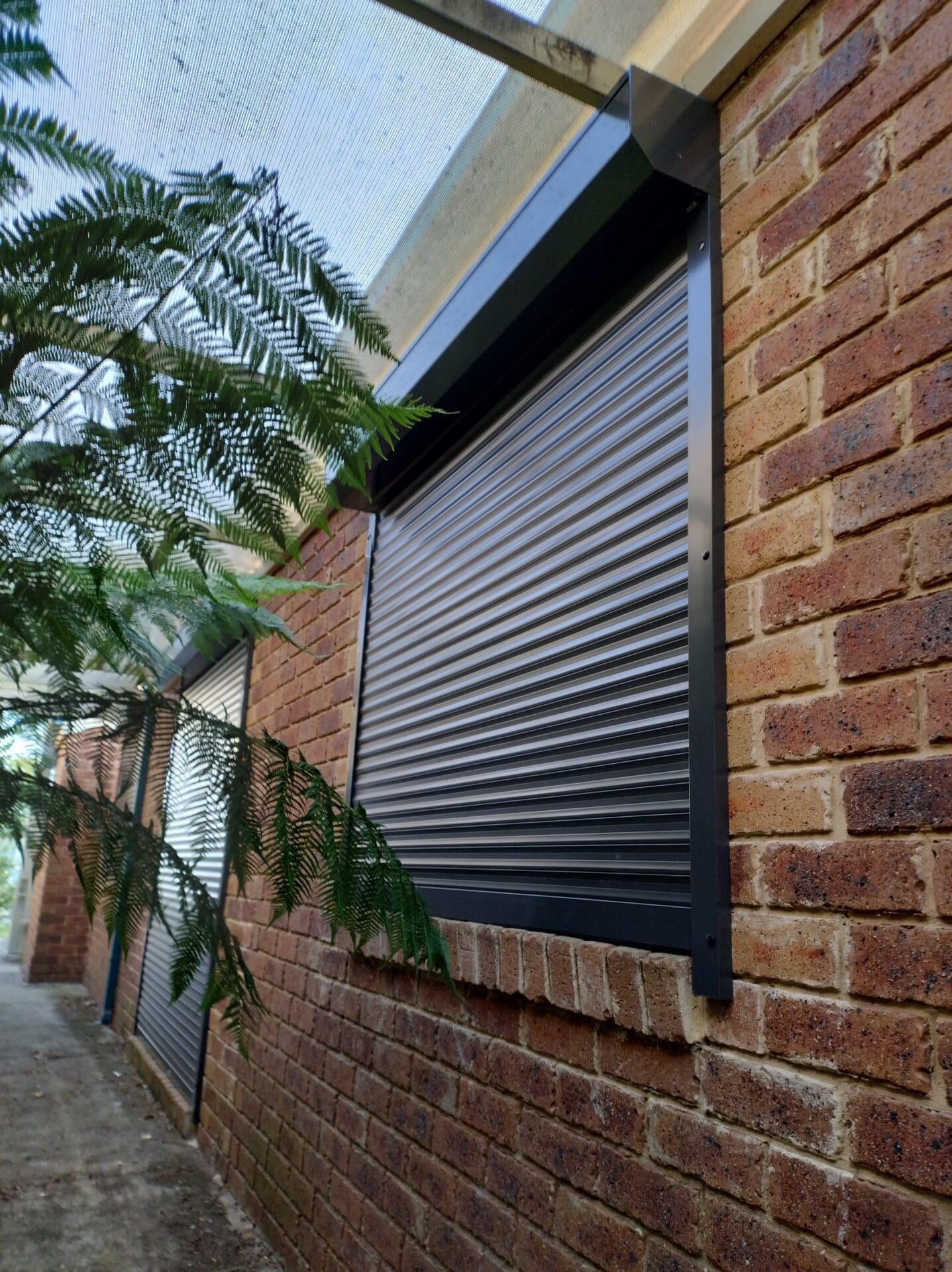 Black Roller Shutters, on the side of the house