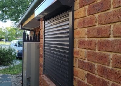 a brick building with a metal shutter