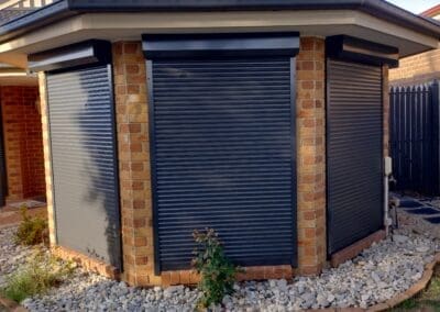a building with a black shuttered door