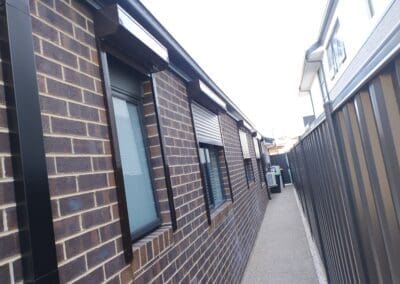a brick building with windows and a fence