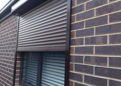 shutter on the side of a brick building