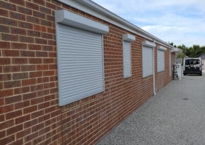 a brick building with windows and blinds