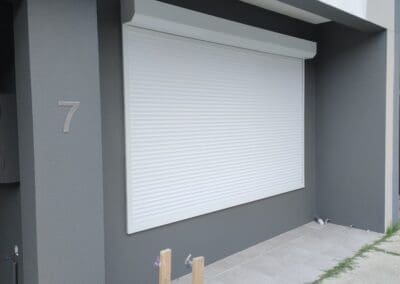 a building with a white shutter window