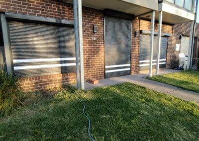 a building with a lawn and a hose